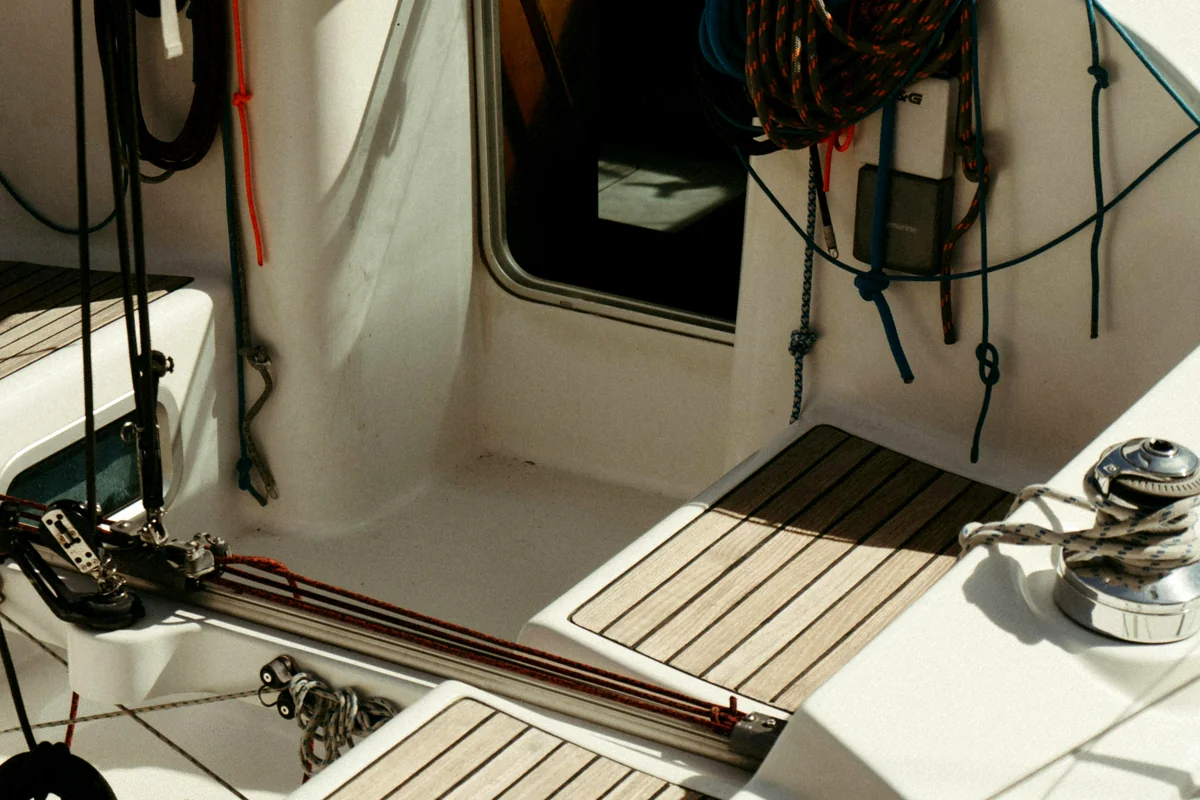 Cockpit with light deck panels, winches, rope, and clean hatch edges.